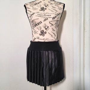Black, small, above the knee pleated skirt.
